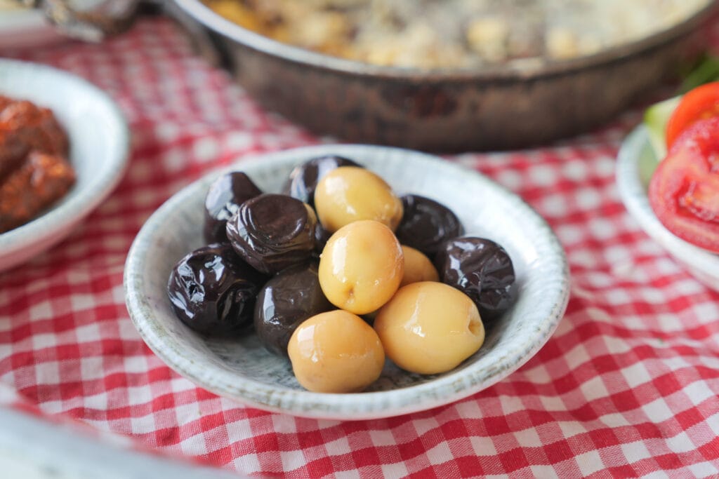 What Moroccan People Eat for Breakfast: Discover Moroccan Meals 7 medium collection of black and green olives with leaves www.moroccaneats.com