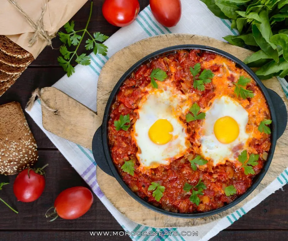 Moroccan-Style Shakshuka: The Addictive Brunch You Didn't Know You Needed 7 Meal-prepped Moroccan shakshuka in containers with ingredients like harissa and preserved lemon displayed on a rustic kitchen counter.