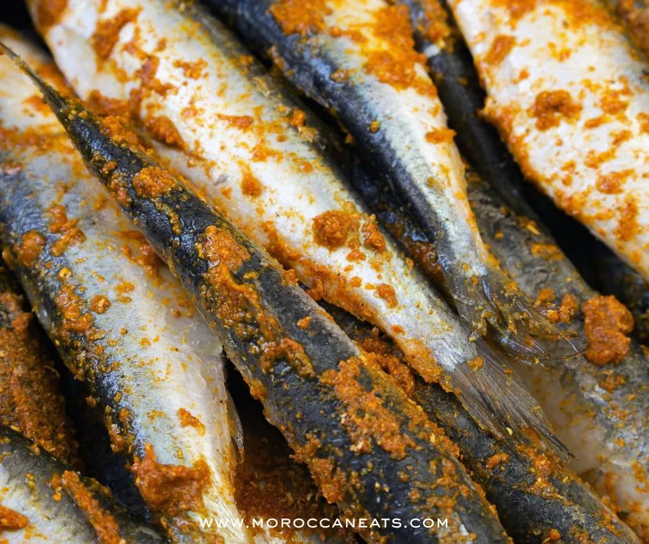 Spicy Moroccan Sardine Sandwich Recipe-Simply Irresistible 4 Assembly of a Moroccan sardine sandwich with traditional ingredients on a rustic table – MoroccanEats