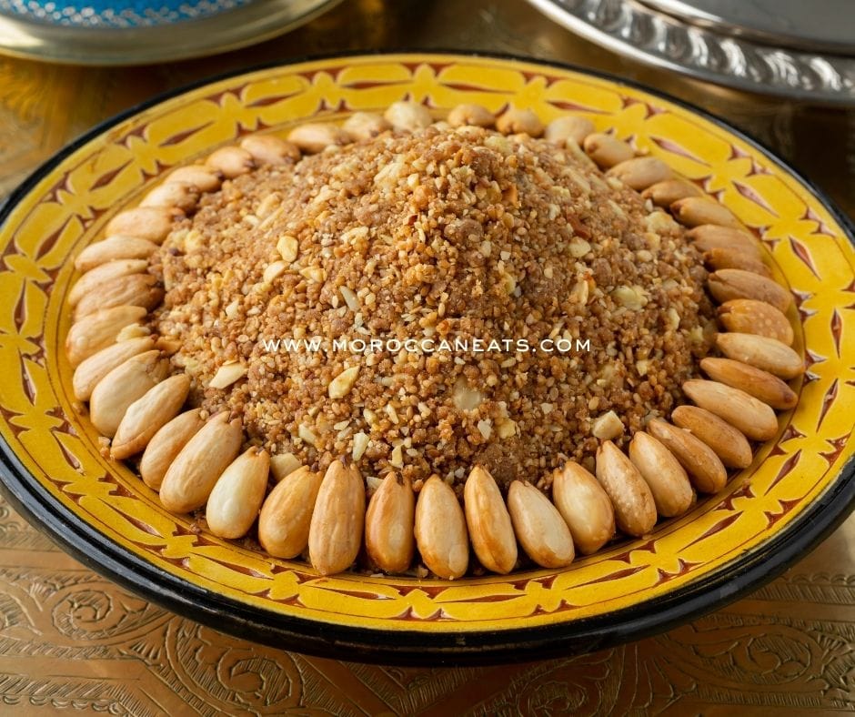 Sellou Delight: Uncover This almonds Joyful Moroccan Treat 2 A decorative plate of traditional Moroccan sellou with almonds and sesame, served during Ramadan, styled with Moroccan fabrics and tea.
