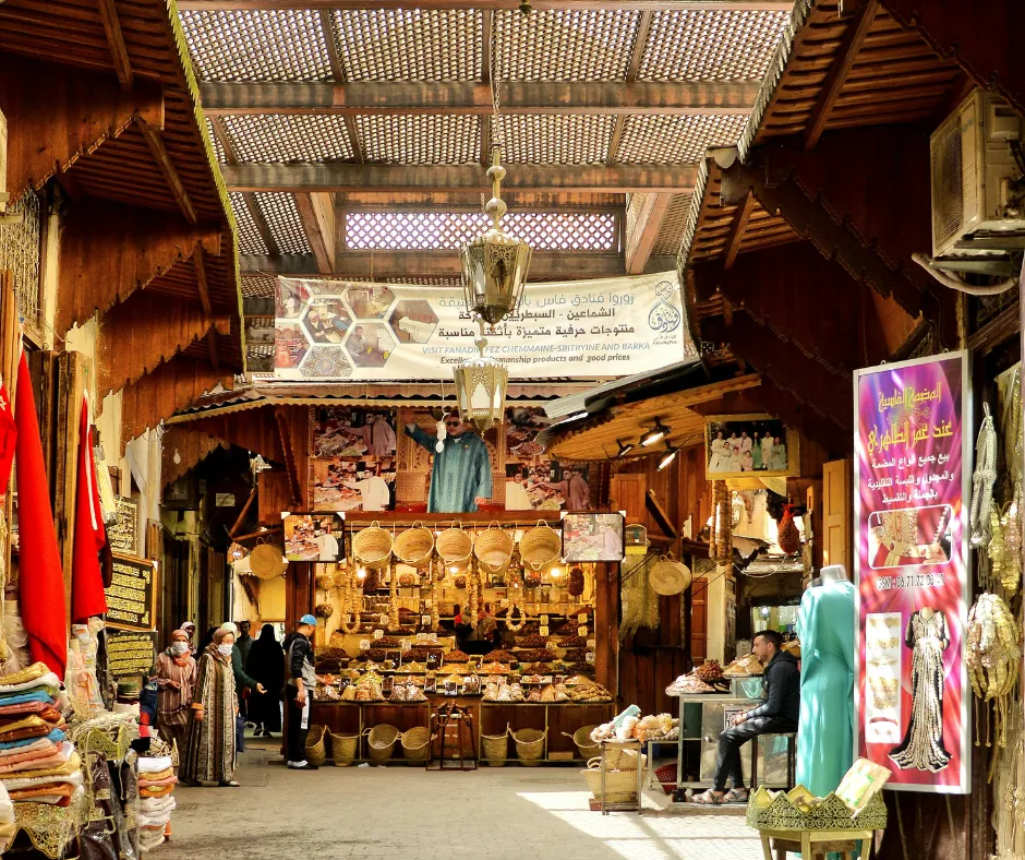 Bustling famous Moroccan street foods market at sunset with colorful stalls, spices, and vendors serving traditional dishes.